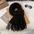 Detail of a black milk velvet scarf with fringe tassels on a stylish fashion display - Black