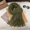 Detailed texture of moss green knitted scarf with long tassels and soft milk fleece fabric - Army Green