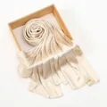 Close-up of champagne scarf showing crocodile texture on a wooden tray - 165cmx75cm / Beige