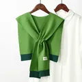 Detail of green knitted shawl with twist design and geometric squid pattern labels - Knitted Twist (Dark Green Ribbed) / Green