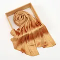 Detail of champagne gold scarf with embossed snakeskin texture on a wooden frame tray - 165cmx75cm / Caramel color