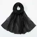 Detail of black semi-transparent scarf showing silky texture and elegant glossy finish - Black