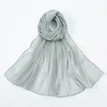 Detail of silver long scarf showing smooth metallic shimmer and delicate hemmed edges - Light Gray