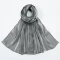 Close-up of shimmering silver-grey silk scarf showing premium fabric texture and metallic shine - Dark Gray
