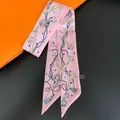 Pink luxury silk twilly scarf with retro key and polka dot patterns on orange gift bag - Pink