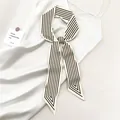 Detailed view of the black and white striped silk twilly scarf with elegant diagonal cut - Beige