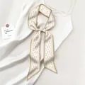 Close-up of beige paisley silk twilly scarf with geometric borders on satin fabric - 130x7cm / Beige Paisley