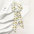 Elegante beige zijden sjaal met gele en blauwe bloemmotieven en een satijnen afwerking - Elegant Bloemig ANGHE (Gember SKU)