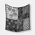 Close-up of lightweight square scarf featuring mixed monochrome floral and wave patterns - Black