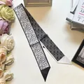Macro detail of high-quality black and white silk twilly with geometric patterns - Geometric Line