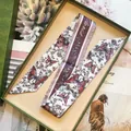 Detail of floral butterfly silk twilly with Paris script in a green vintage gift box - S2338 Purple