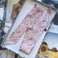 Pink floral silk skinny scarf with butterfly prints in a white gift box on a magazine - Flesh Pink