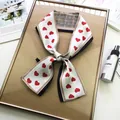 Double-sided narrow scarf with red hearts and classic plaid pattern tied in a bow - Red