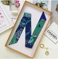 Blue-green floral narrow silk scarf for bag handle in an orange gift box with birds - Green