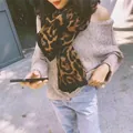 Close-up of leopard print long scarf with black edge detail worn by a model outdoor - 175cm / Coffee