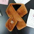 Close-up of ginger brown faux rabbit fur scarf with soft texture and crossover design - Caramel color