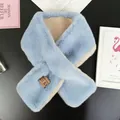 Detail shot of plush faux rabbit fur scarf in light blue with beige lining and logo patch - Teal