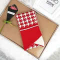 Red and white houndstooth knitted scarf with button detail on cozy wooden tray - 100cm-135cm / Red