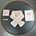 Detail of pink faux fur scarf with gold metallic woven trim and soft plush texture - Pink
