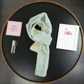 Detail of mint green faux rabbit fur scarf with knitted texture and Beloved label - Mint Green / 162cm