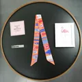 Elegant orange silk twilly scarf with horse harness patterns in a stylish French design - Orange