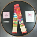 Macro view of artistic Van Gogh oil painting style skinny silk scarf with vibrant red tones - Van Gogh Series / Red House