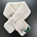 Detail of soft faux fur scarf with colorful plush pom-poms on grey background - Milk Tea