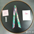 Detailed view of green and pink geometric print twilly silk scarf tied on a luxury bag - Green White Rose Chain (S177-9)