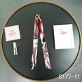 Detailed view of a slim black twilly scarf with elegant chain and belt patterns - Black Base Red Pink White Belt (S177-11)