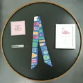 Detail of navy silk twilly scarf featuring multicolor belt and buckle prints - Light Blue