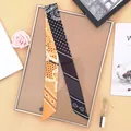 Orange paisley and black polka dot narrow silk scarf tied on a display frame - Yellow and Black