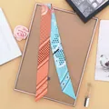 Orange and light blue paisley print long silk scarf tied elegantly as a bag accessory - Orange And Mint Green