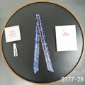 Detail of navy blue twilly scarf with golden chain print on a luxury display tray - Dark Blue Chain (S177-28)