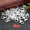 Bulk silver lobster claw clasps for DIY jewelry making on dark wood background - Silver