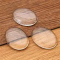 Three transparent oval glass cabochons on a rustic wood background for DIY jewelry - 28x38mm Oval Glass Cabochon