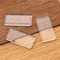 Three rectangular transparent glass cabochons on a wooden background for DIY crafts - 23x33mm Rectangle Glass Cabochon