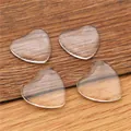 Clear heart-shaped glass cabochons for DIY jewelry making on natural wooden background - 33mm Heart Glass Cabochon