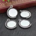 Macro shot of four antique silver rotating pendant trays with beaded edges for DIY jewelry - Antique Silver