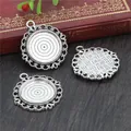 Three antique silver round alloy pendant trays with vintage floral edges on a wooden table - Vintage Hollow Round Disk (D2-30) / Antique Silver