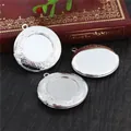 Macro detail of three silver copper photo lockets with vintage floral relief on wood - Silver