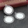 Three antique silver round DIY pendant trays with lace edges on dark wood background - Lace Border Round Tray (D2-16)