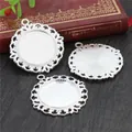 Detailed view of silver alloy lace pendant trays on a vintage wood and book backdrop - Silver Hollow Style (A3-48)