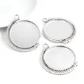 Macro detail of silver round alloy pendant trays with beaded edges for DIY jewelry making - White K/Silver