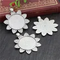 Three antique silver sunflower alloy pendant trays for DIY jewelry making on wooden background - Sunflower Alloy Shape Style (A4-02)