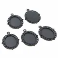 Macro detail of black oval lace alloy pendant trays with textured back and top loop - Black Hollow Lace Style (D2-44)