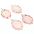 Detail view of four rose gold oval alloy pendants with vintage hollow lace borders for DIY - Rose Gold Vintage Hollow Lace Style (D2-52)