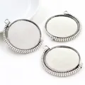Close-up of three 30mm silver alloy rotating pendant trays with beaded edges for DIY jewelry - Antique Silver