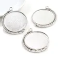 Macro detail of three silver beaded edge rotating alloy pendant trays for DIY crafts - White K/Silver