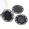 Detail view of black vintage lace alloy pendant bases with intricate hollow floral texture - Black Oval Filigree Bezel