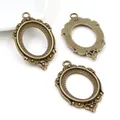Three antique bronze oval pendant trays for DIY jewelry making on a white background - Antique Bronze
